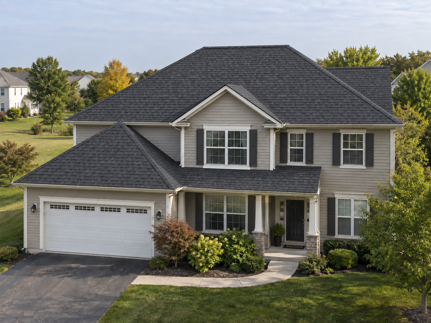 A gray-sided two-story Illinois home, restored roof